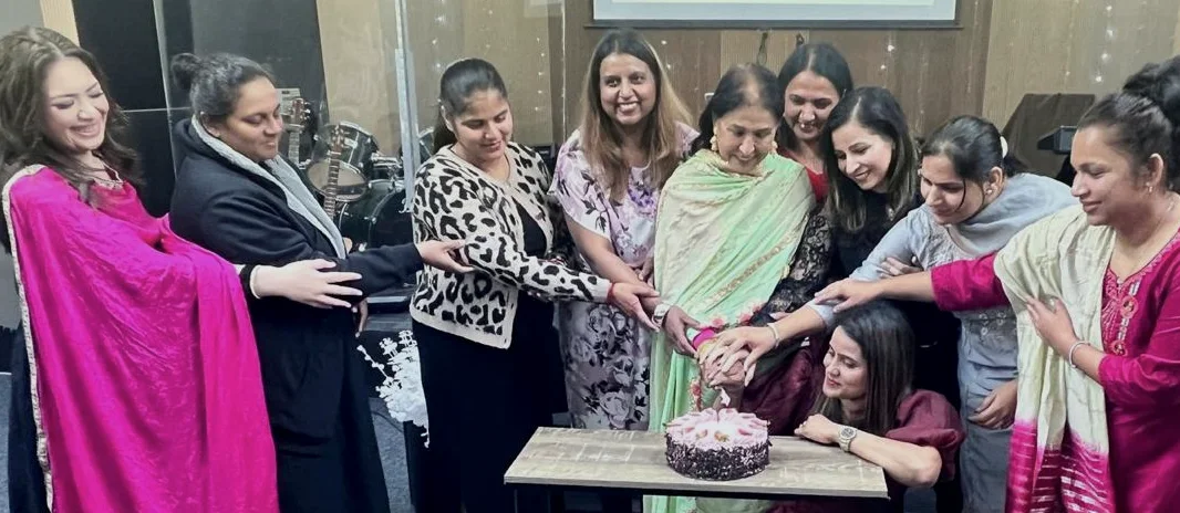 Members of the church celebrating together around a cake