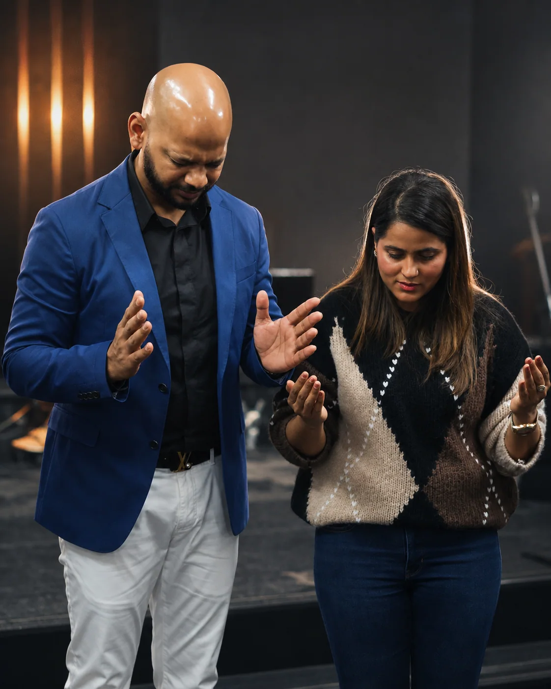 Pastor Vikas and Pastor Jyoti Garg praying together during a service