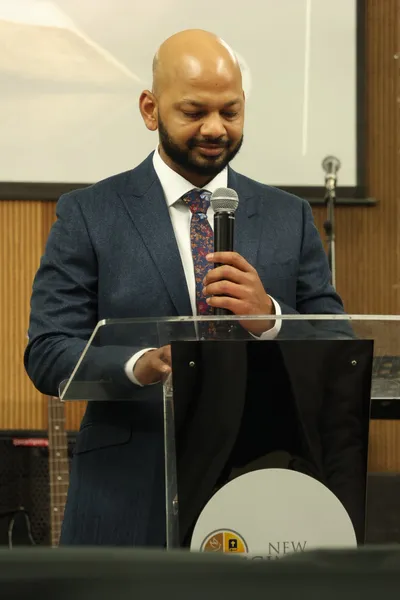 Pastor Vikas preaching at the pulpit on a Sunday