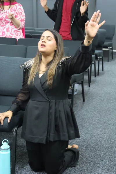 Worshipping with hands raised during the service