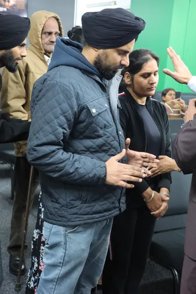 Praying a blessing over an elderly couple