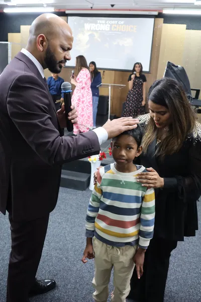 Praying over a young member of the church