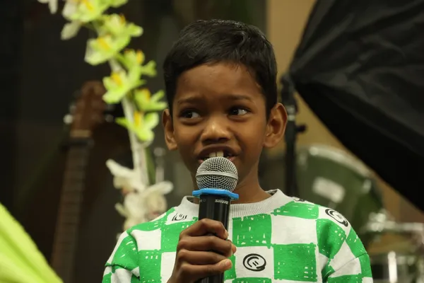 A young member reciting a memory verse
