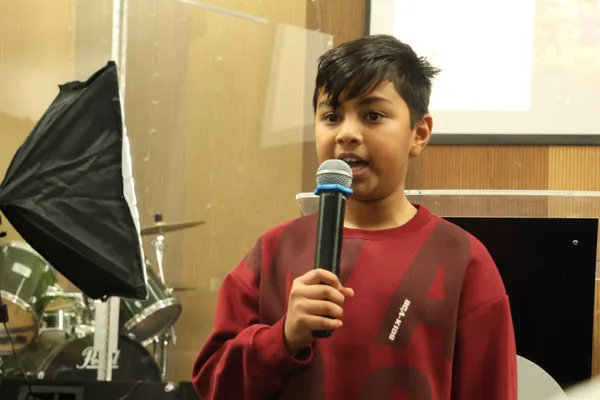 Reciting a verse in front of the church