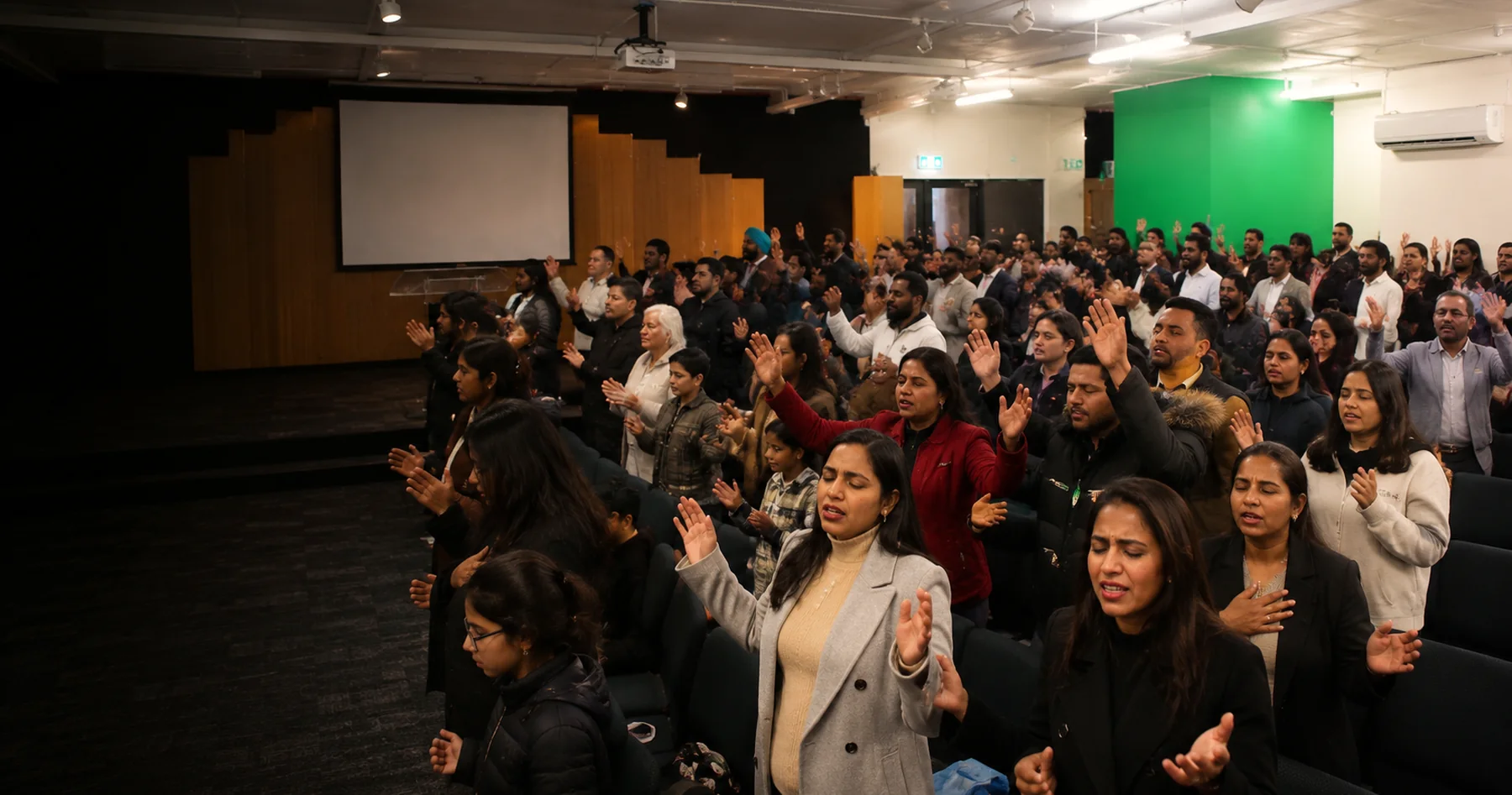 The congregation standing in worship during a Sunday service
