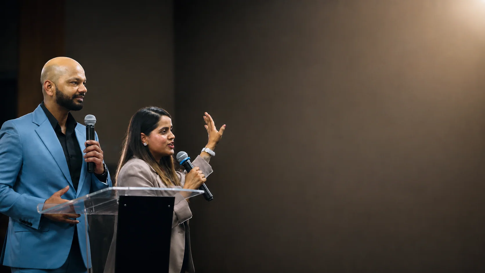 Pastors Vikas and Jyoti Garg speaking together at the lectern