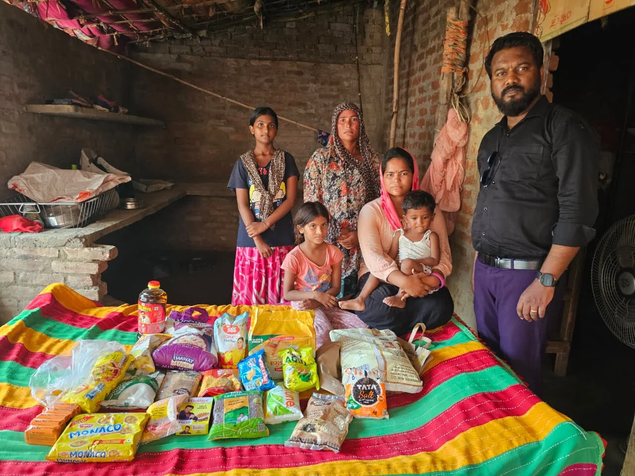 A family standing together with the provisions delivered to their home